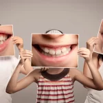 Smiling children holding close-ups of smiles. Children need fluoride to safeguard their teeth from cavities.